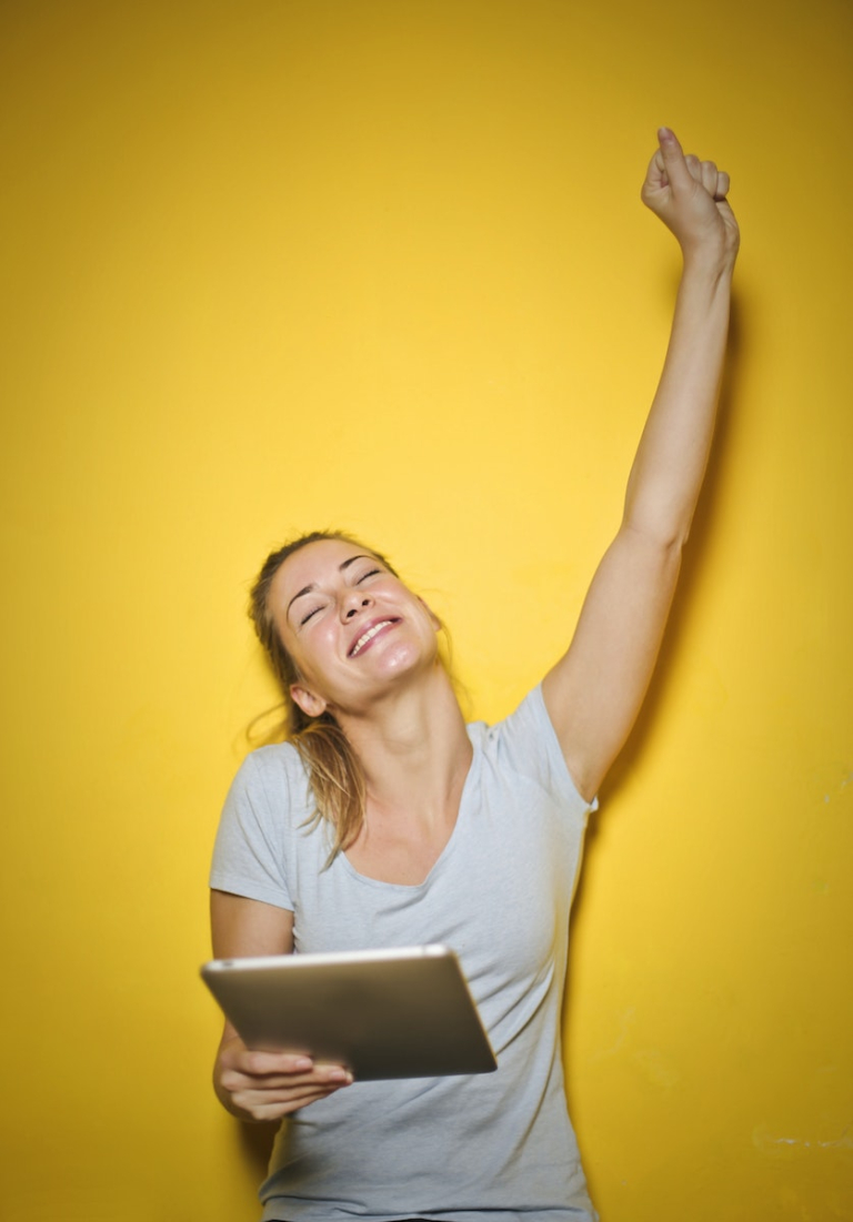 Photo of a Woman Holding an Ipad