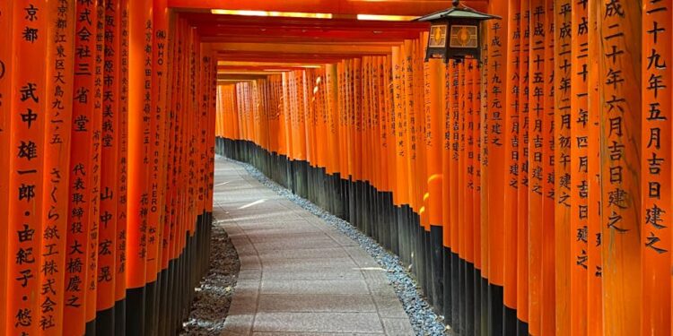 Iconic orange torii gates at Fushimi Inari Shrine in Kyoto, Japan.