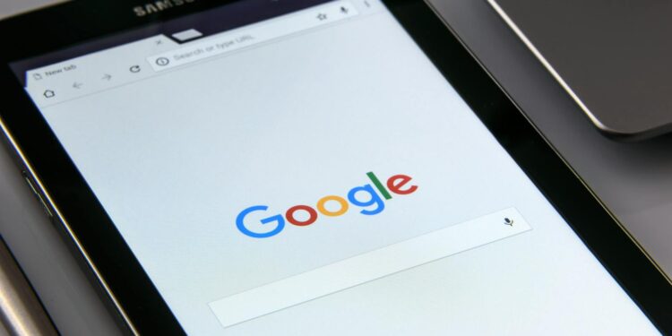 Close-up of a tablet displaying Google's search screen, emphasizing technology and internet browsing.