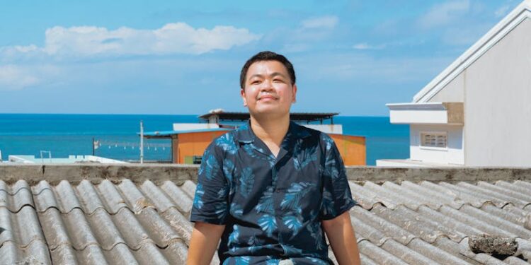 Man enjoys sunny day on rooftop overlooking the sea in Bình Thuận, Vietnam.
