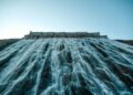 A breathtaking view of water cascading from a dam, capturing the power and beauty of nature.