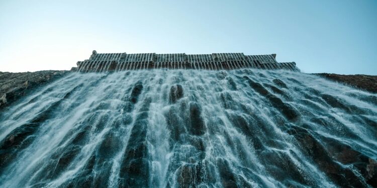 A breathtaking view of water cascading from a dam, capturing the power and beauty of nature.