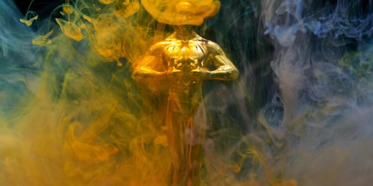 A golden statuette enveloped in vibrant yellow and blue smoke, symbolizing achievement and success.