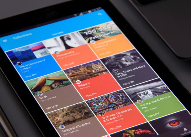 Close-up of a tablet displaying diverse content collections in a grid format.