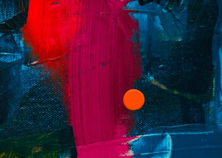 Dynamic close-up of a colorful abstract acrylic painting featuring bold textures.