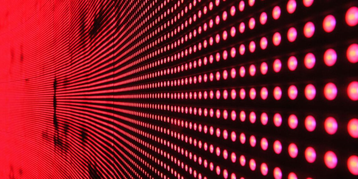 Vibrant abstract pattern of illuminated red LED lights forming a dynamic design.
