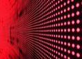 Vibrant abstract pattern of illuminated red LED lights forming a dynamic design.