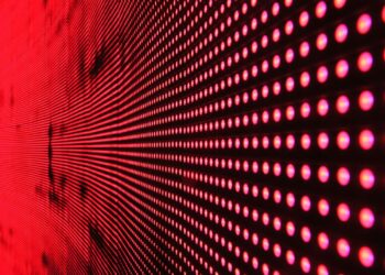 Vibrant abstract pattern of illuminated red LED lights forming a dynamic design.