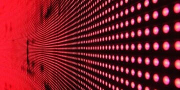 Vibrant abstract pattern of illuminated red LED lights forming a dynamic design.
