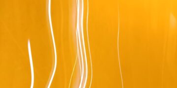 Dynamic abstract image featuring bright yellow light streaks and patterns, ideal for creative projects.