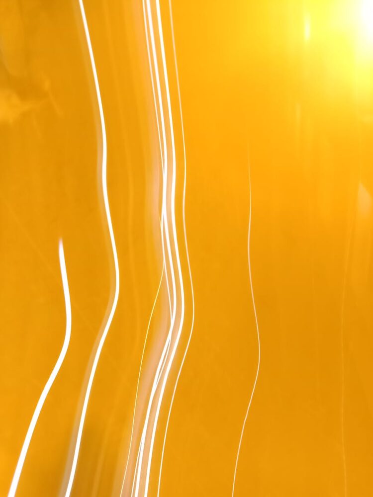 Dynamic abstract image featuring bright yellow light streaks and patterns, ideal for creative projects.