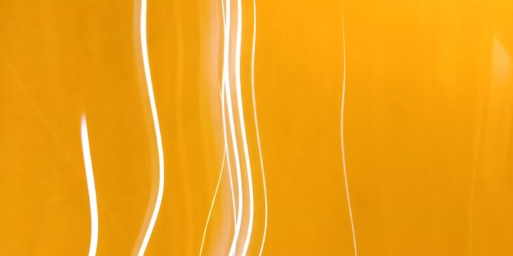 Dynamic abstract image featuring bright yellow light streaks and patterns, ideal for creative projects.