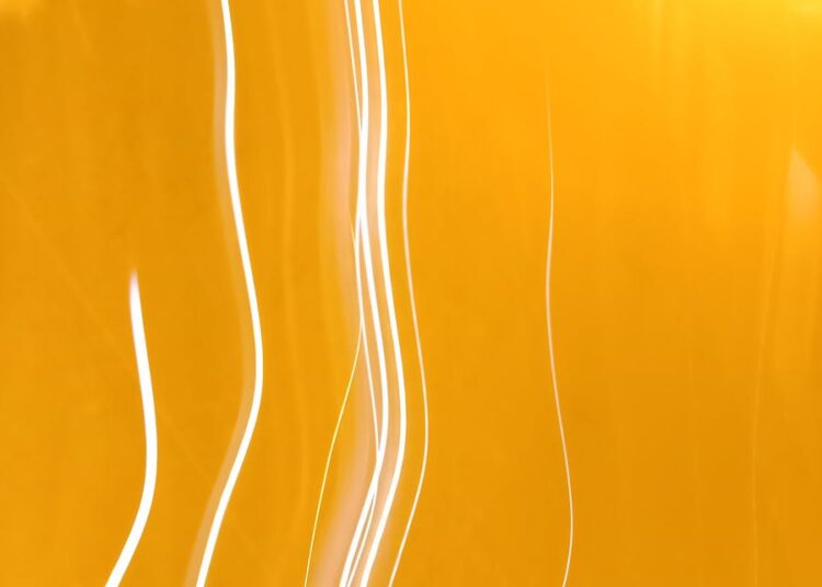 Dynamic abstract image featuring bright yellow light streaks and patterns, ideal for creative projects.