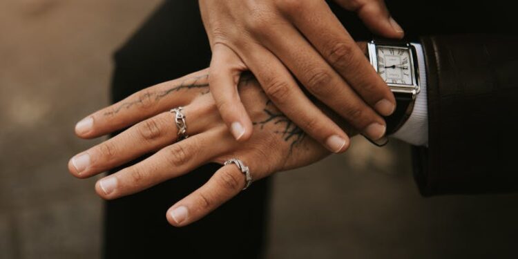 Close-up portrait of a fashionable man with tattoos and rings in Lille, France.