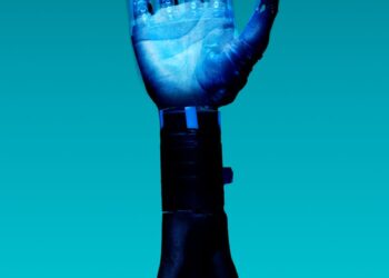 Close-up of a robotic hand showcasing advanced technology against a blue backdrop.