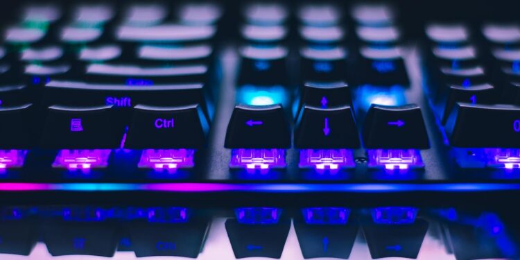 A detailed close-up of illuminated mechanical keyboard keys with focus on blue and purple lights.