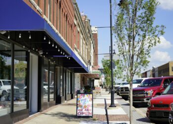 a sidewalk with cars parked on the side