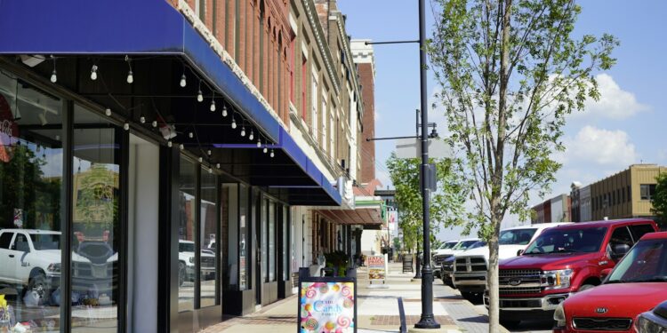 a sidewalk with cars parked on the side