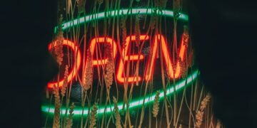 a neon sign that is on the side of a building