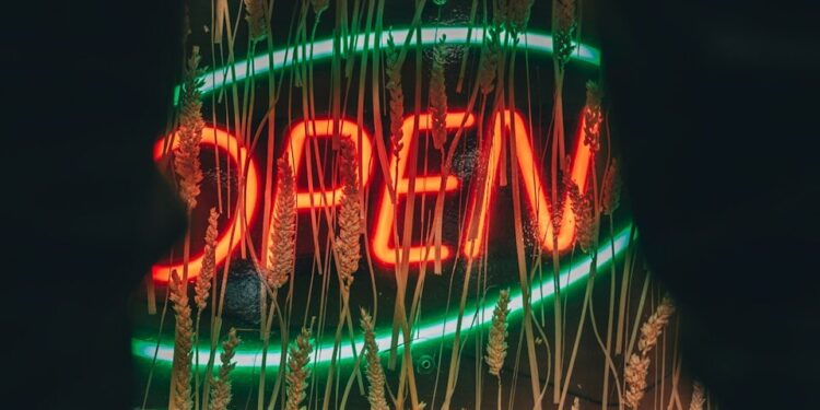 a neon sign that is on the side of a building