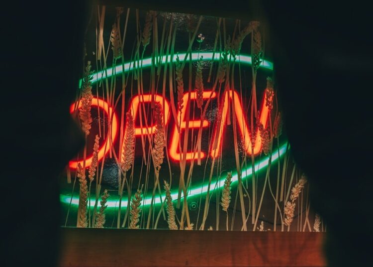 a neon sign that is on the side of a building