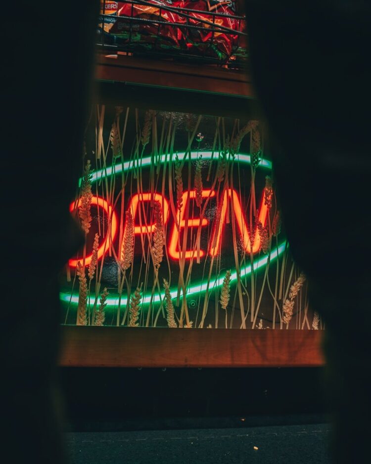 a neon sign that is on the side of a building