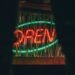 a neon sign that is on the side of a building