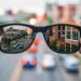 aSmart glasses reflecting a city street, symbolizing the independence AI glasses give to blind veterans