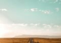 Open road stretching toward the horizon, a symbol of hope and forward progress