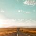 Open road stretching toward the horizon, a symbol of hope and forward progress
