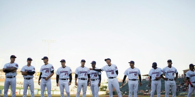A baseball team lined up together on the field
