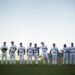 A baseball team lined up together on the field