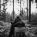 Hiker with a backpack walking through a quiet forest