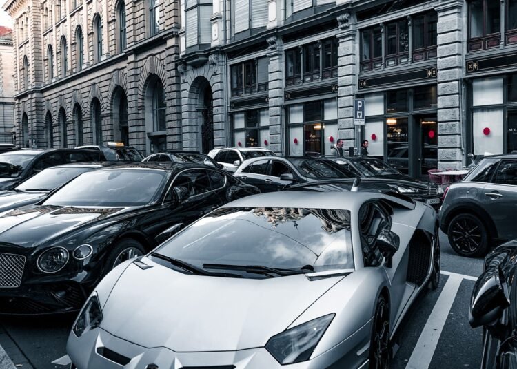 Luxury sports cars parked on an urban street, Positive Phil