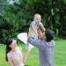 A father lifting his baby boy in a garden, Positive Phil