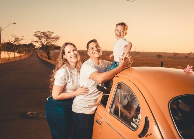 A happy family on a sunset road trip with a vintage car, Positive Phil