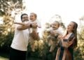 A happy family with two children playing outdoors in summer, Positive Phil