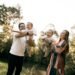 A happy family with two children playing outdoors in summer, Positive Phil