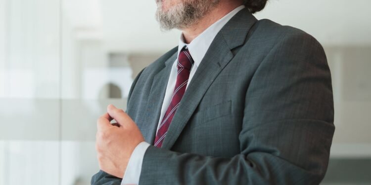 A businessman adjusting his cufflinks, Positive Phil