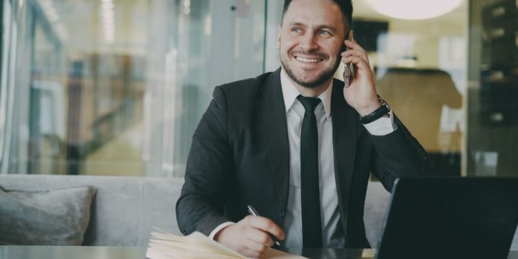 A smiling businessman on a phone call, Positive Phil