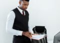 A man reviewing documents at his desk, Positive Phil