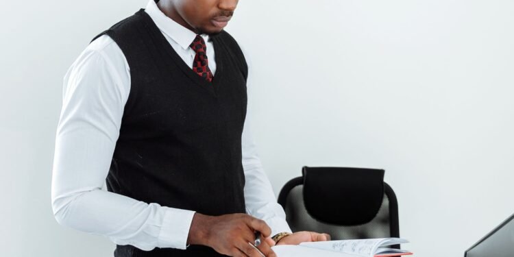 A man reviewing documents at his desk, Positive Phil