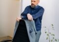 A bearded man standing in an office, Positive Phil