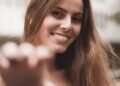 A young woman smiling on a sunny day outdoors, Positive Phil