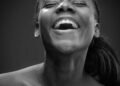 A joyful smiling woman in a studio portrait, Positive Phil