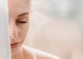 Woman with eyes closed in soft morning light