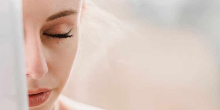 Woman with eyes closed in soft morning light