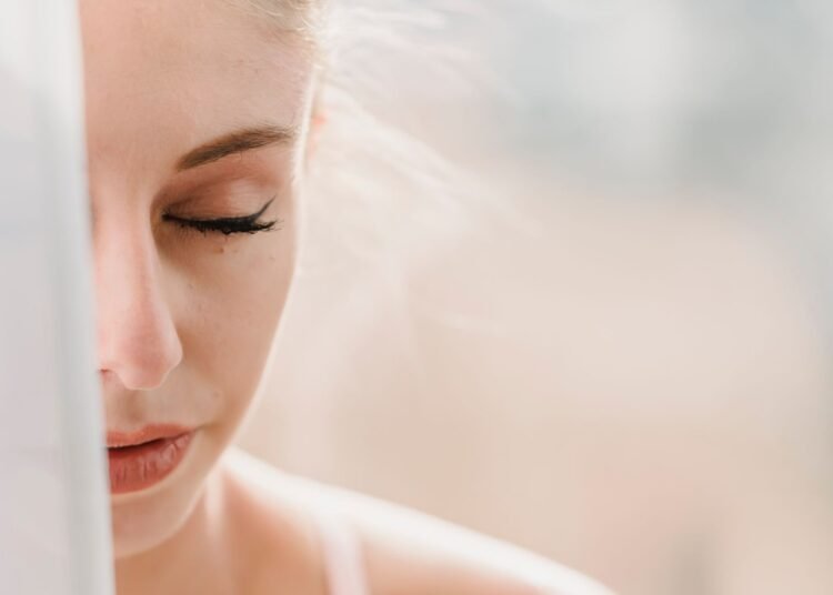 Woman with eyes closed in soft morning light