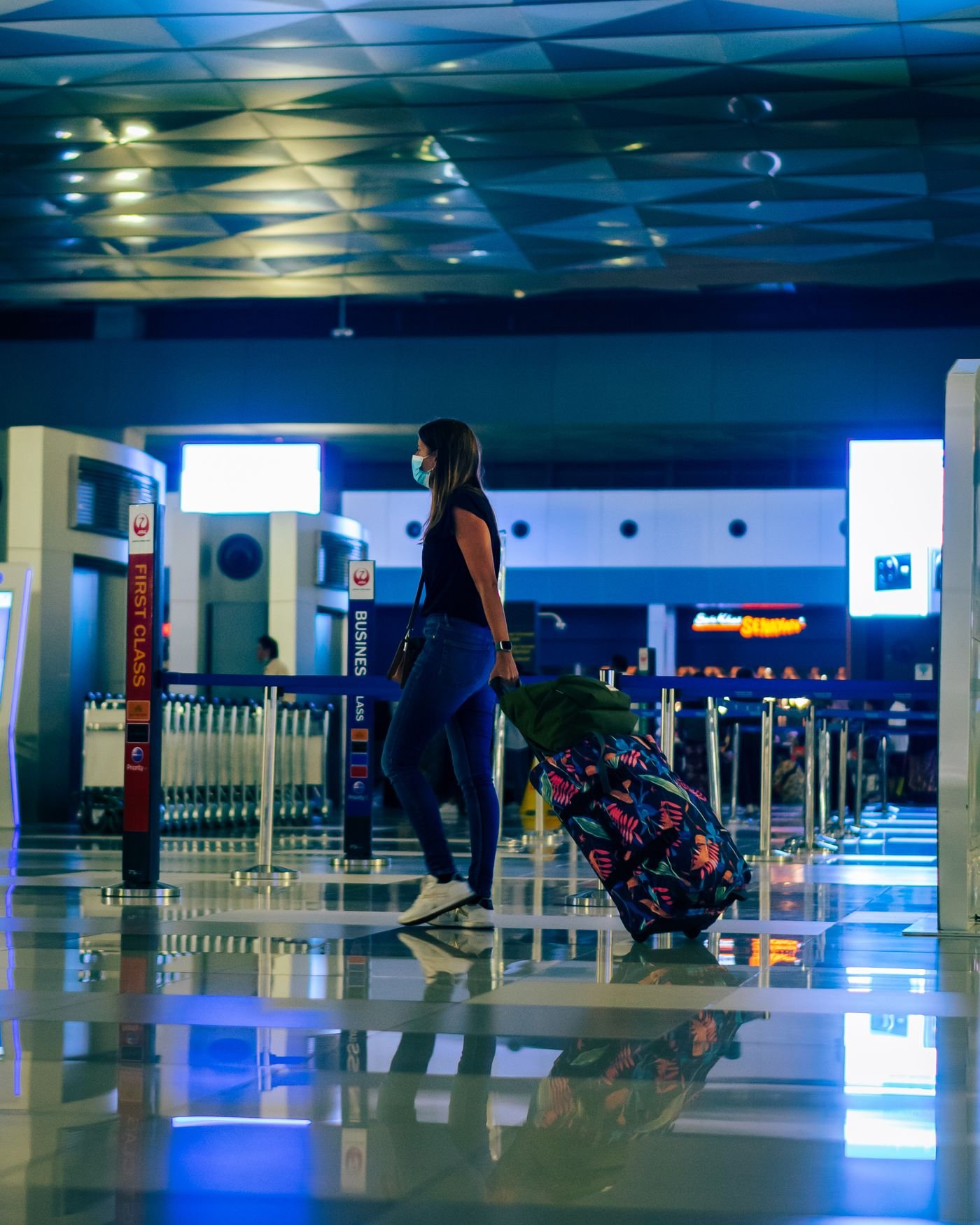 A woman with her luggage at an airport