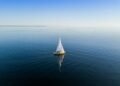 sailboat calm sea sunrise